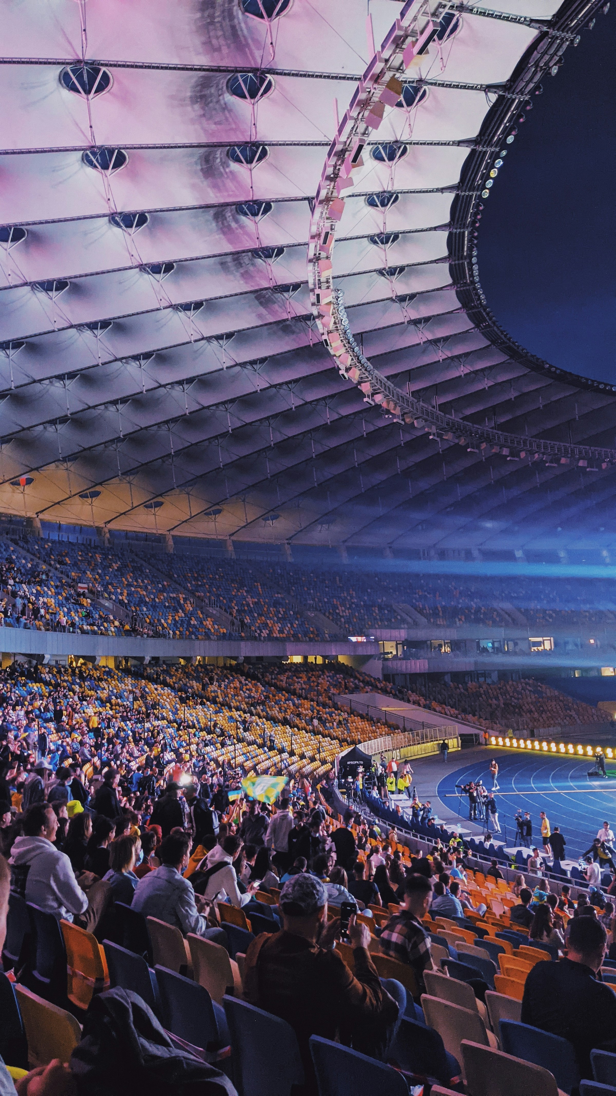 A packed football stadium illuminated at night